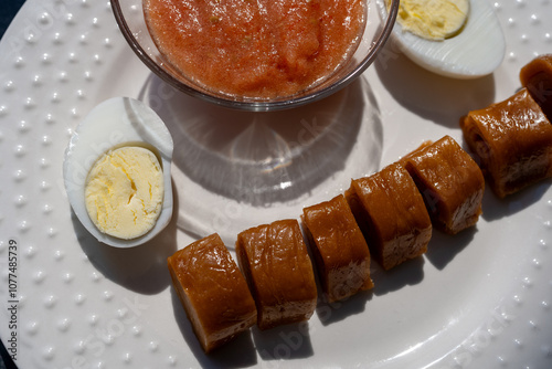 Traditional Jachnun Served With Hard-Boiled Eggs And Tomato Sauce photo