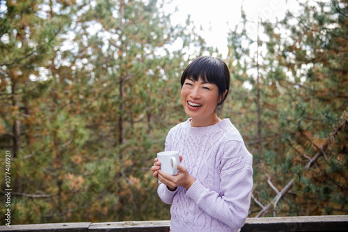 Happy young woman holding coffee cup photo