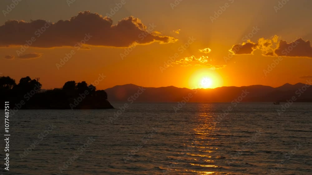 Nightfall towards sea waves. An orange nightfall sky over the calm waves of the bay. Nightfall towards sea waves. An orange nightfall sky over the calm waves of the bay.