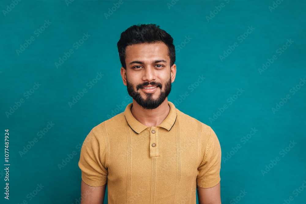 Portrait of Indian man against blue backdrop. Portrait of Indian man against blue backdrop.