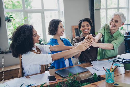 Photo of corporate four colleagues women feminists community give high five leadership meeting coworking successful nice light office photo