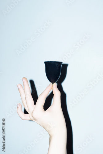 Hand holding menstrual/period cup reusable sustainable period product photo