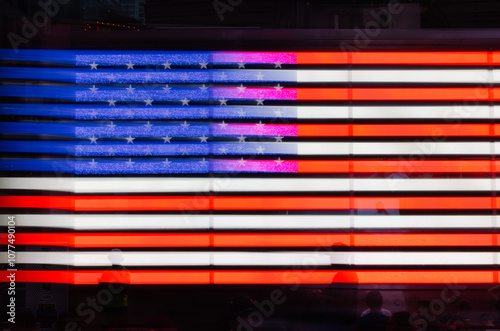 Reflection of American flag at night in New York City Times Square photo