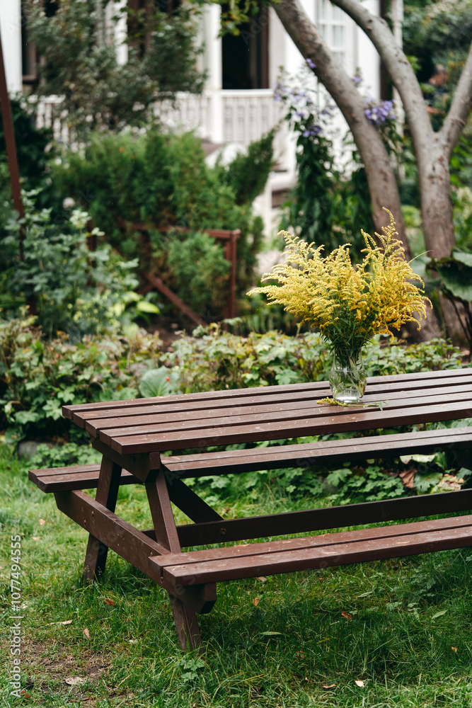 A Rustic Garden Table Adorned With Vibrant Flowers A Rustic Garden Table Adorned With Vibrant Flowers