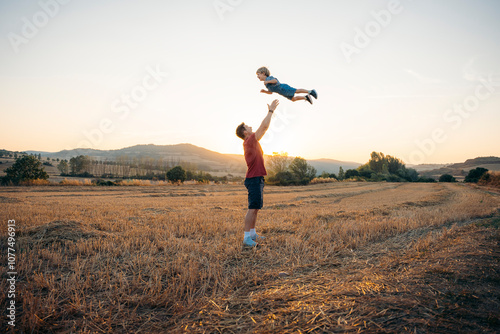 Father Tossing Child in the Air photo