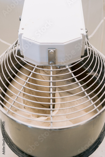 Dough mixing in an industrial mixer machine. photo