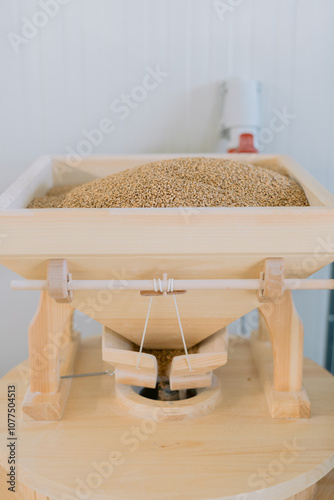 Grains in traditional wooden grain mill. photo