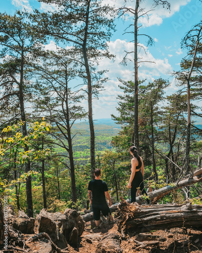 Couple hiking in the mountains of North Carolina on sunny summer afternoon at the top of Crowder's Mountain photo