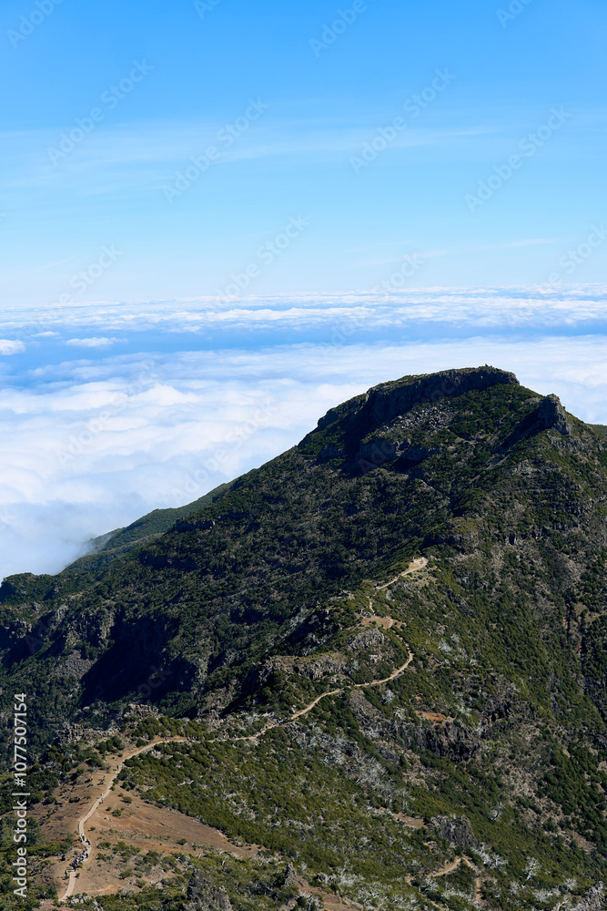 Stunning aerial view of a mountain peak above clouds on a clear day showcasing natural beauty and serene landscape Stunning aerial view of a mountain peak above clouds on a clear day showcasing natural beauty and serene landscape