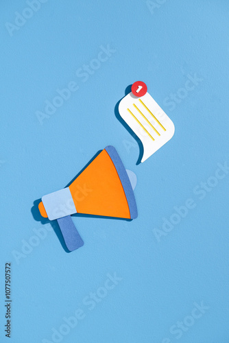Creative Megaphone Design with Notification Symbol on Blue Background photo