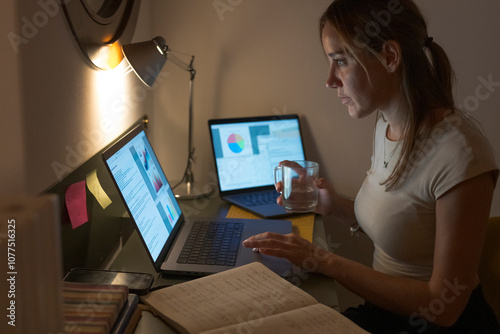 Woman working late on laptop at home office