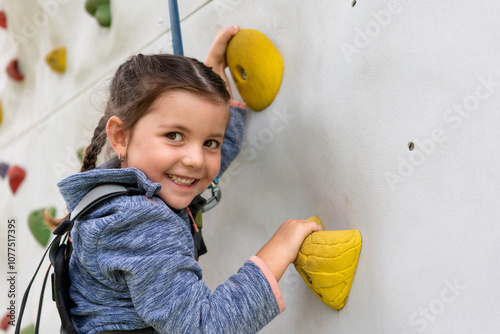 Happy little girl climbing 