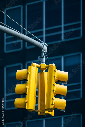 Iconic yellow traffic light against a modern building in New York photo