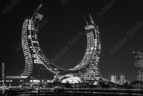 black and white to the newly developed lusail city with winter wonderland and crescent tower in the background.