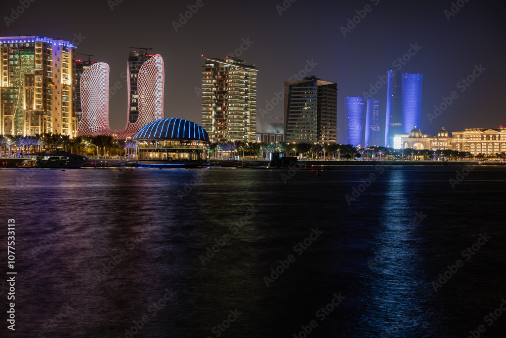 Fototapeta premium Lusail marina night view with Yachts and boats with Qatar flag and Lusail skyline in background