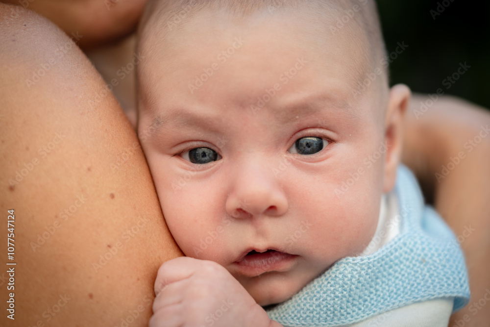 Newborn baby boy resting on mother's shoulder Newborn baby boy resting on mother's shoulder