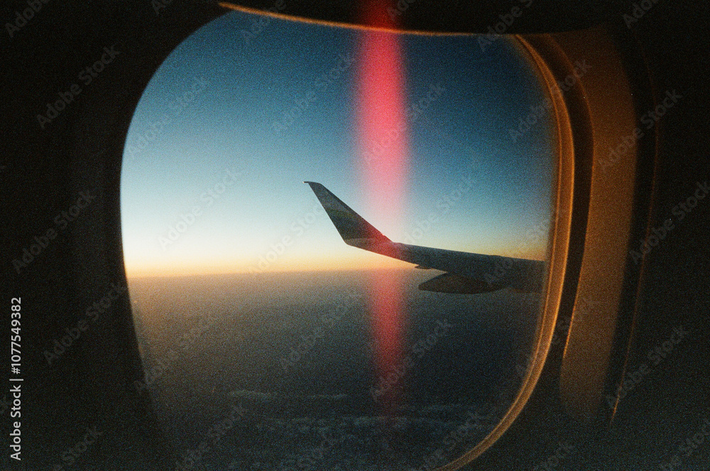 © Sean Flanigan/Stocksy - light leak frame an airplane