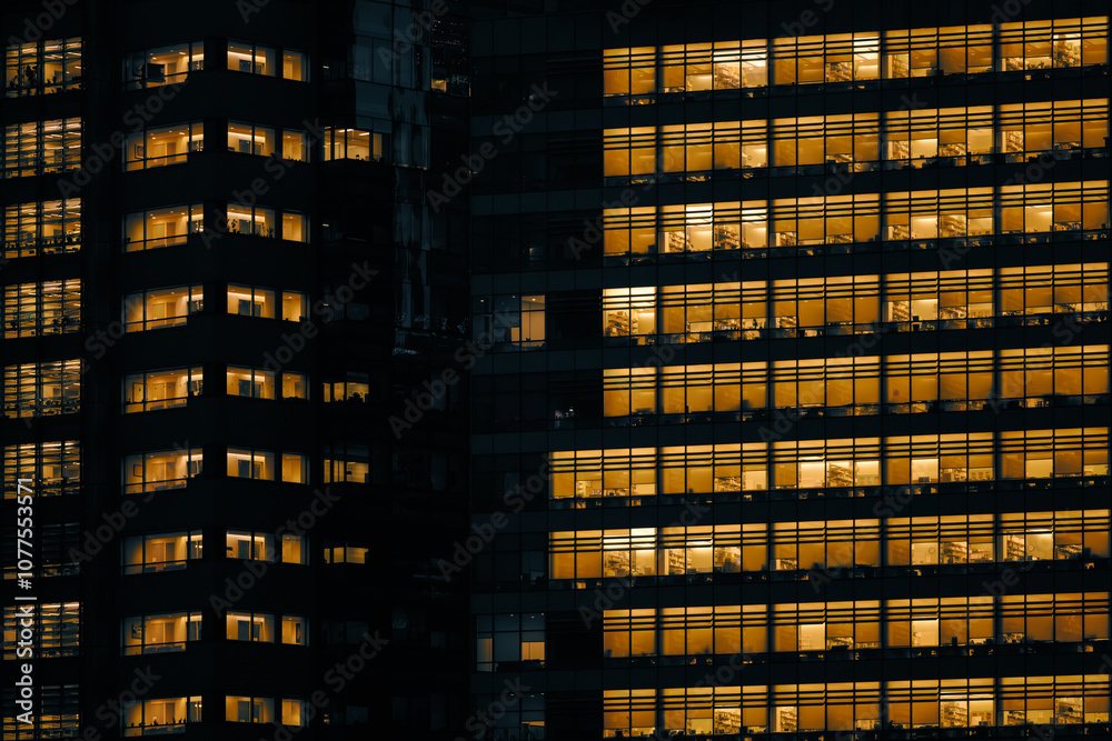 Illuminated office building windows at night in NYC Illuminated office building windows at night in NYC