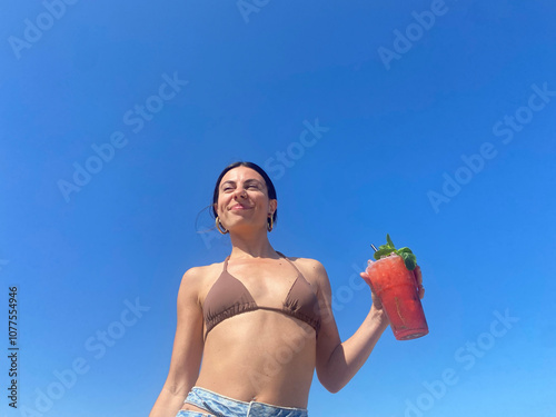 Enjoying a Refreshing Drink on a Sunny Beach Day photo