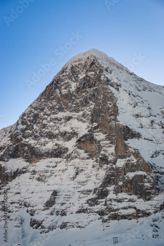 Obraz na płótnie Scenic view of snowcovered Eiger mountain in Switzerland in winter early in the morning against blue sky w salonie