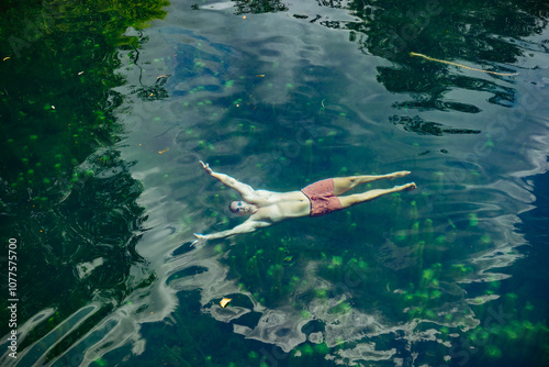 Man Floating Peacefully in a Clear Green Lagoon photo