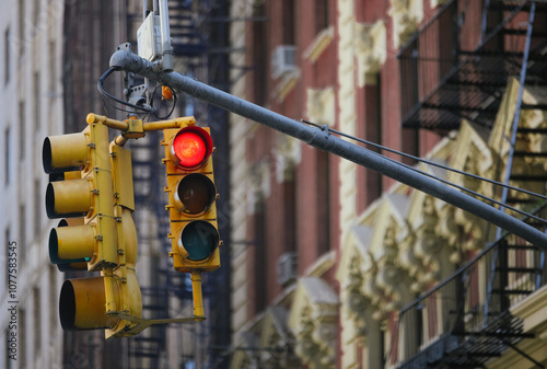 Traffic light with red signal in New York City urban streets