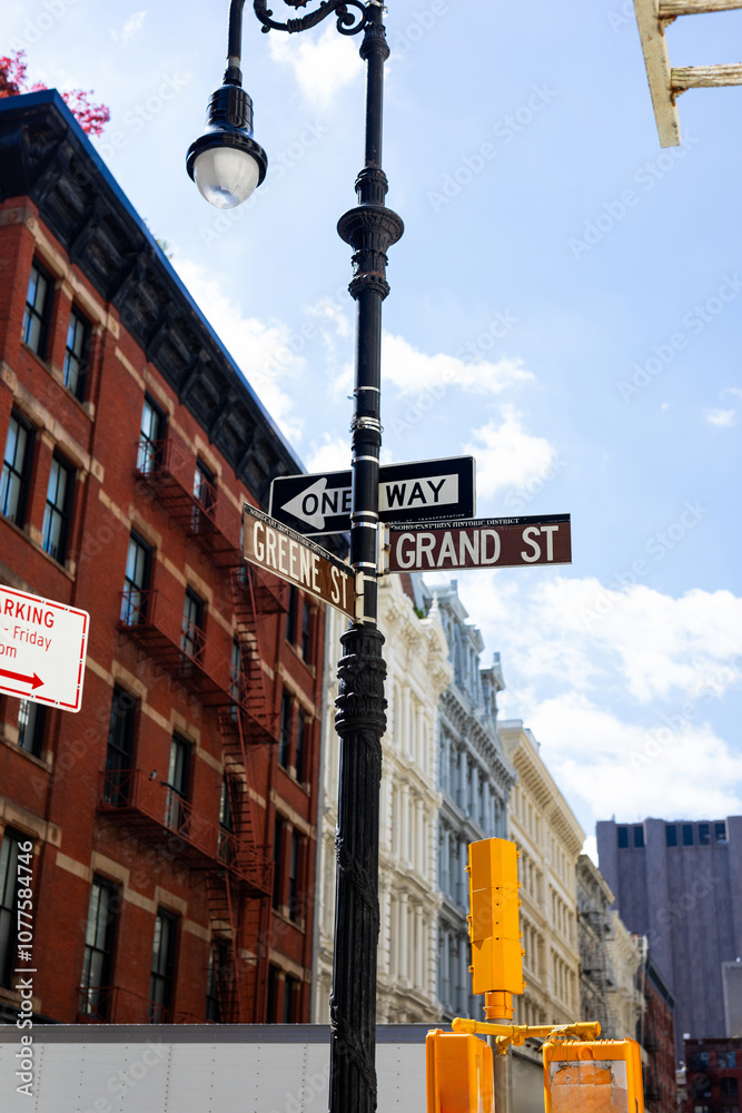 Road name signage placed on a street light on a corner in New York Road name signage placed on a street light on a corner in New York