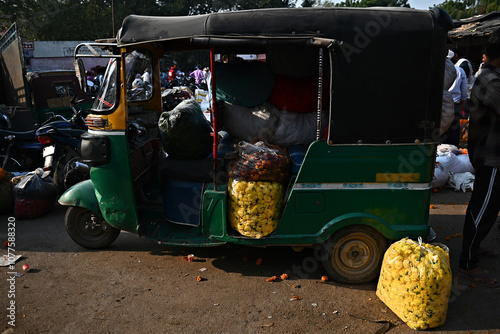Flowers are loaded into an autorickshaw in a market in India