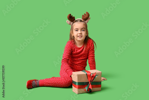 Cute little girl in reindee...