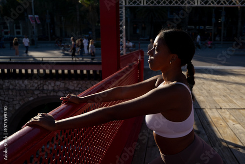 Woman Stretching On Bridge photo