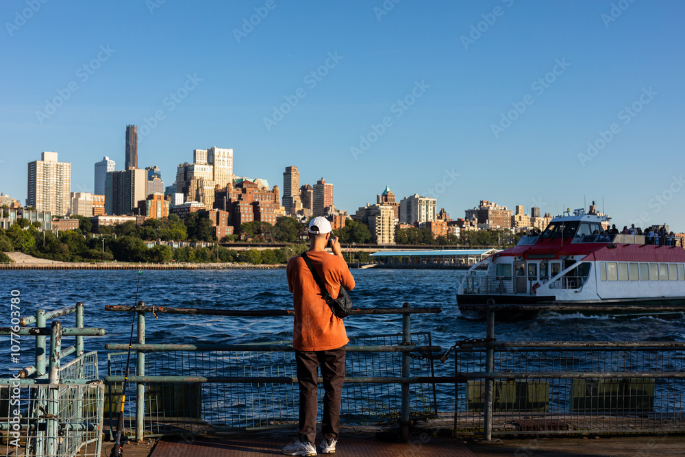 Tourist enjoys vacation in New York photographing a views of the city Tourist enjoys vacation in New York photographing a views of the city