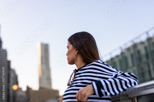 Female vacationer takes in the New York City skyline on a calm day