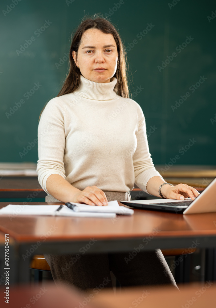 Adult female student preparing for exams in the university classroom Adult female student preparing for exams in the university classroom
