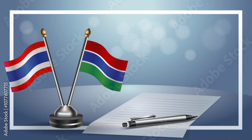 Thailand and Gambia National flags on small table with bokeh background, cooperative relationship