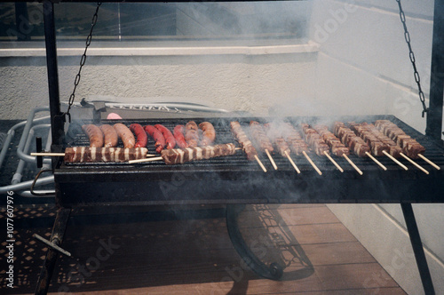 Grilled Meat And Sausages Smoking On A Skewer Barbecue Grill photo