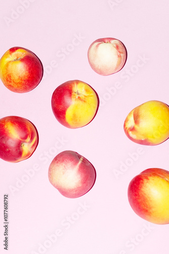 Delicious  fresh juicy peach fruits on pink desk with hard flashlight photo