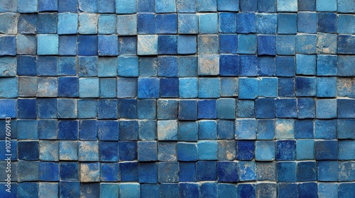 A close-up of a wall covered in blue tiles, creating a mesmerizing and textured surface.