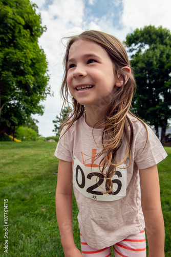 Portrait of happy child competing in running race photo