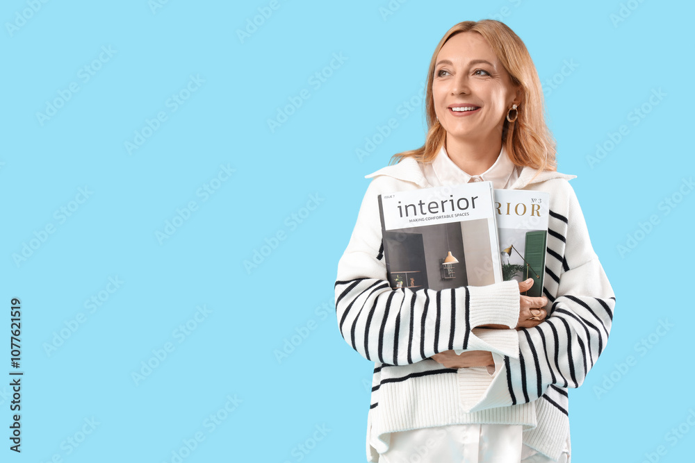 Beautiful mature happy woman with magazines on blue background Beautiful mature happy woman with magazines on blue background