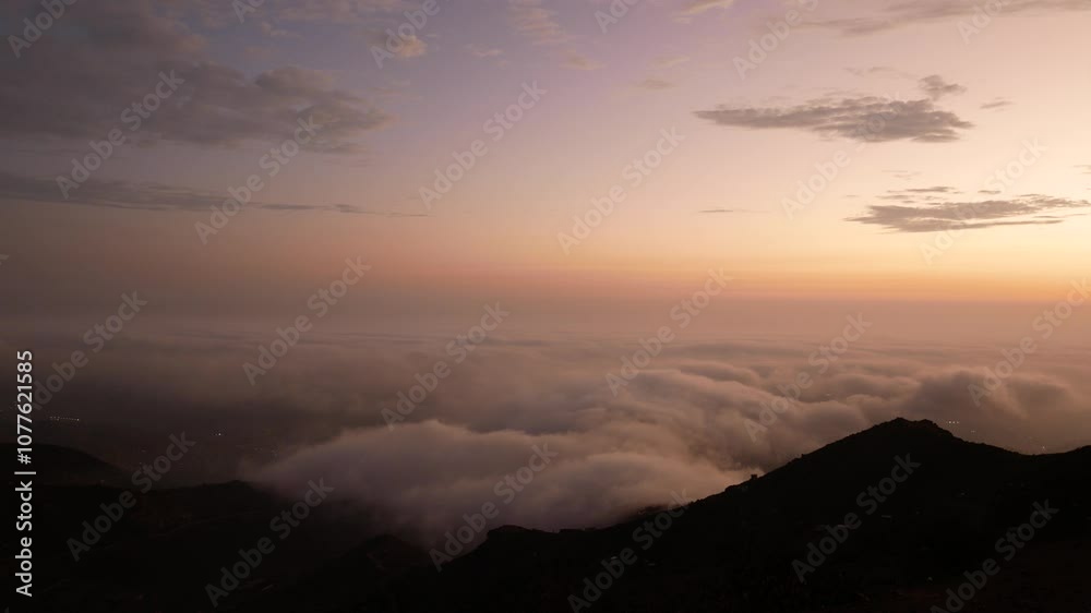 Clouds Between the Hills Seen from the Viewpoint “Apu Siqay”, in Villa del Triunfo, Lima, Peru at Sunset Clouds Between the Hills Seen from the Viewpoint “Apu Siqay”, in Villa del Triunfo, Lima, Peru at Sunset