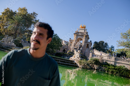 out of focus man laughing with monument photo