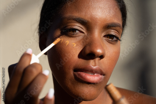 Dominican Woman Putting Foundation  photo