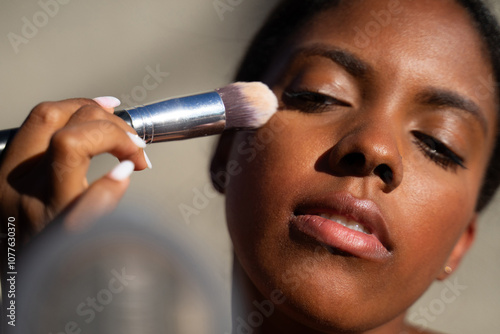 Dominican Woman Applying Powder photo