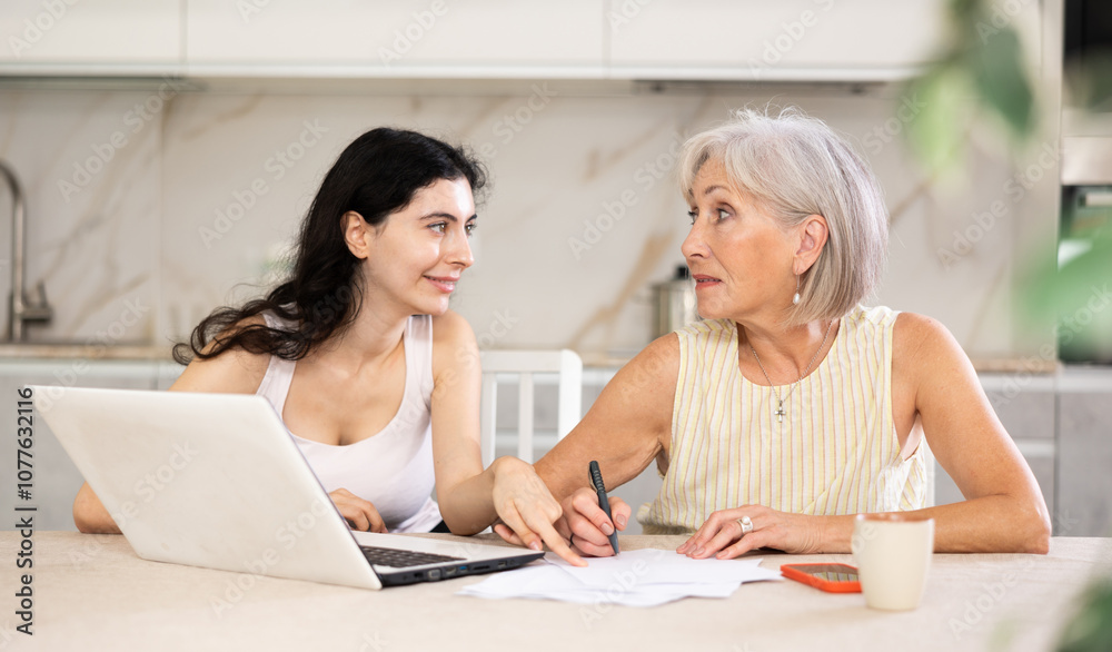 Mature woman consulting with female real estate agent in home interior Mature woman consulting with female real estate agent in home interior