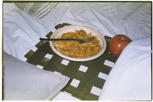 tray with food on an unmade bed, 35mm photo