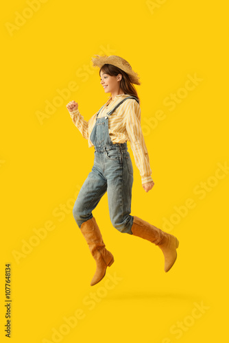 Female farmer jumping on ye...