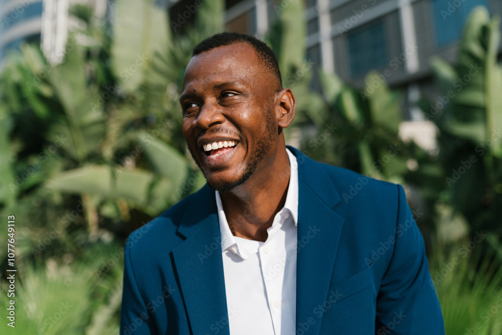 © Ezequiel Giménez/Stocksy - Joyful businessman in blue suit laughing © Ezequiel Giménez/Stocksy - Joyful businessman in blue suit laughing