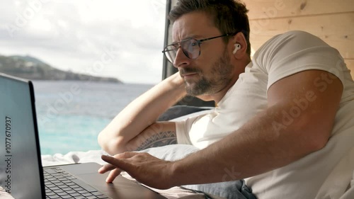 Vanlife working remotely by the beach in a cozy camper van