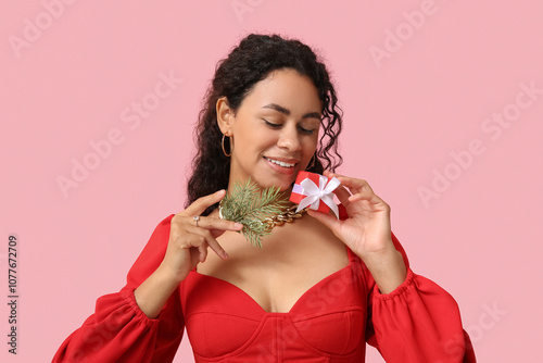 Smiling young woman holding...