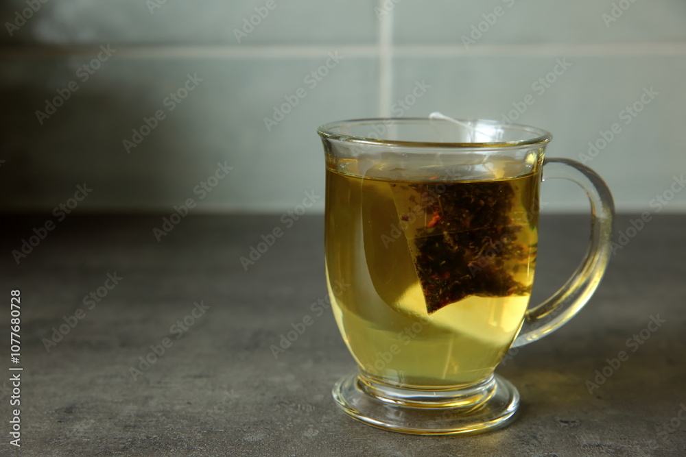 Aromatic and Invigorating Tea in a Clear Glass Mug with Infusion of Natural Leaves Aromatic and Invigorating Tea in a Clear Glass Mug with Infusion of Natural Leaves